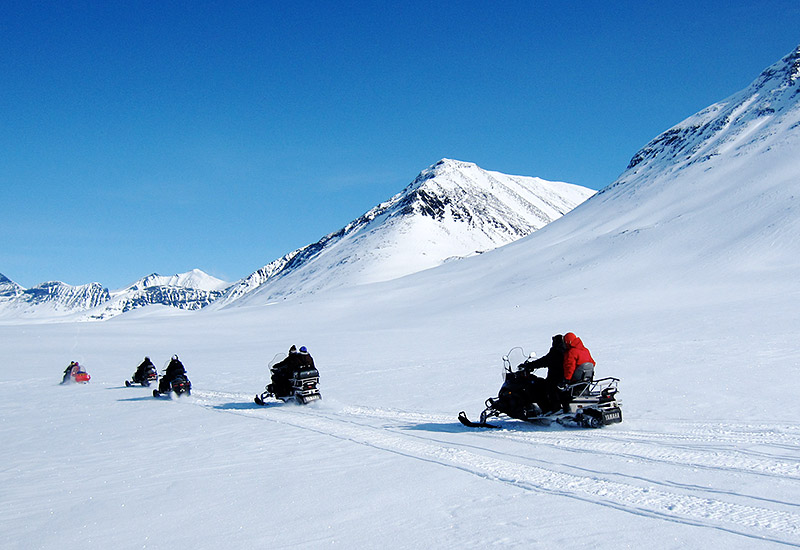 High mountain tour with snowmobile